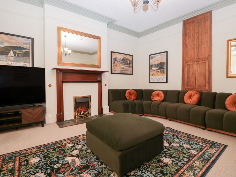 A living room with a sofa and a television at Norwood House in Ambleside