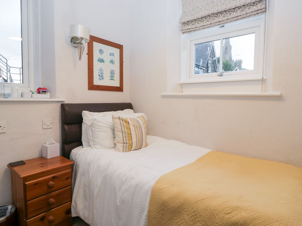 A bedroom with a single bed and a bedside table at Norwood House in Ambleside