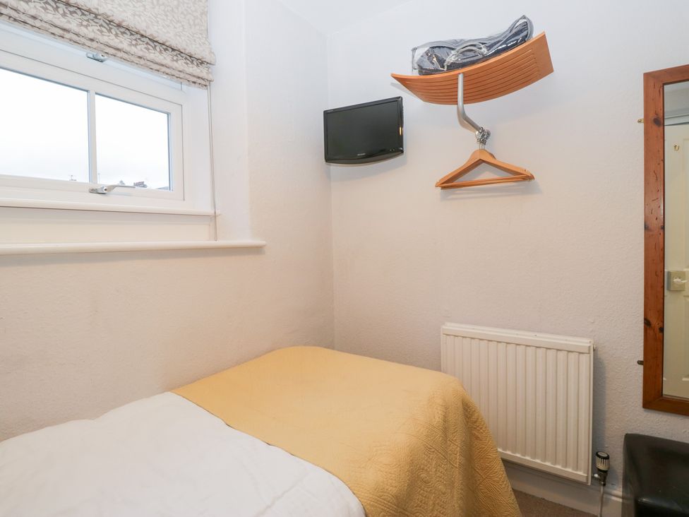 A bedroom with a bed and a television at Norwood House in Ambleside