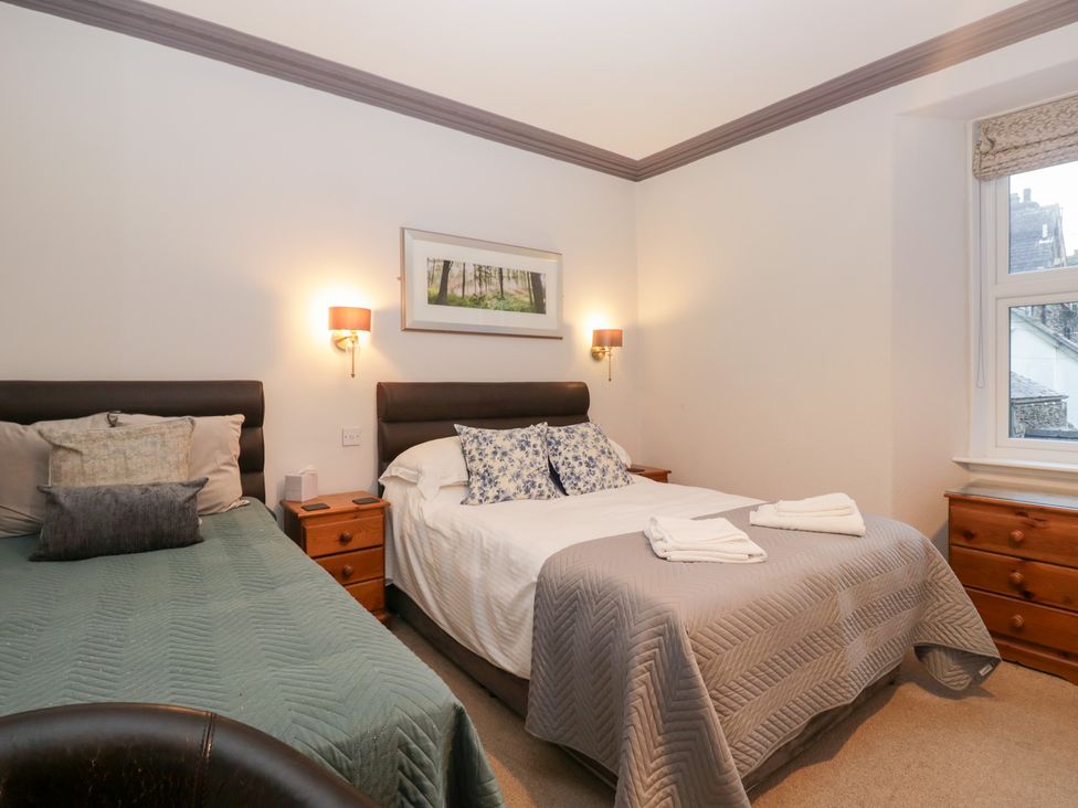 A bedroom with two beds and a window at Norwood House in Ambleside