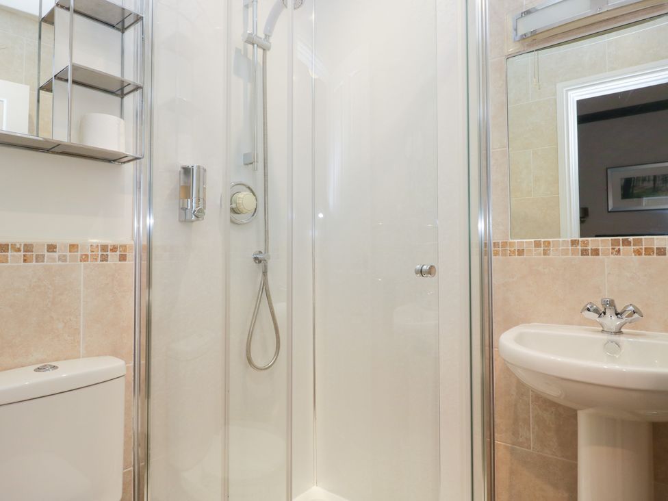 A bathroom with a shower, sink, and toilet at Norwood House in Ambleside