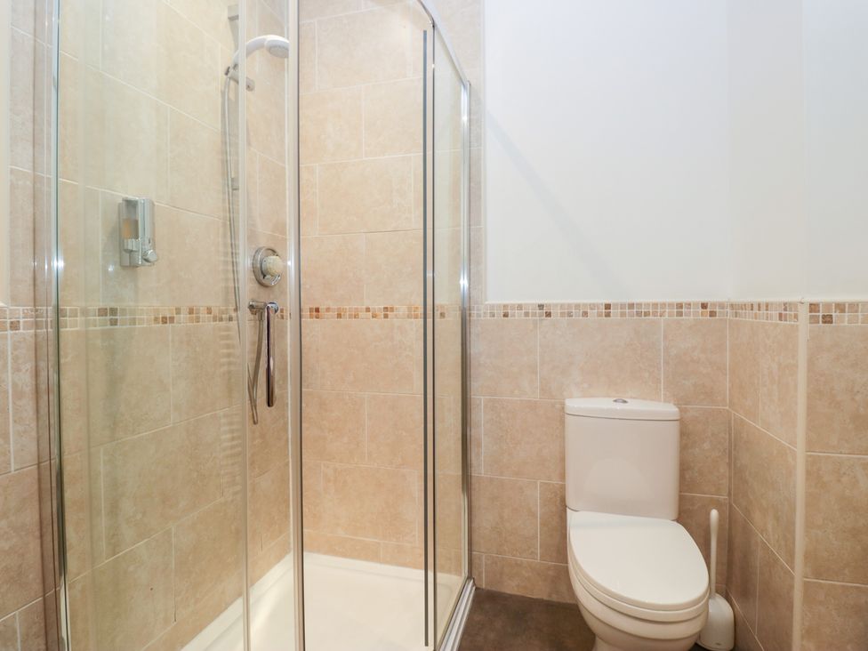 A bathroom with a shower and a toilet at Norwood House in Ambleside