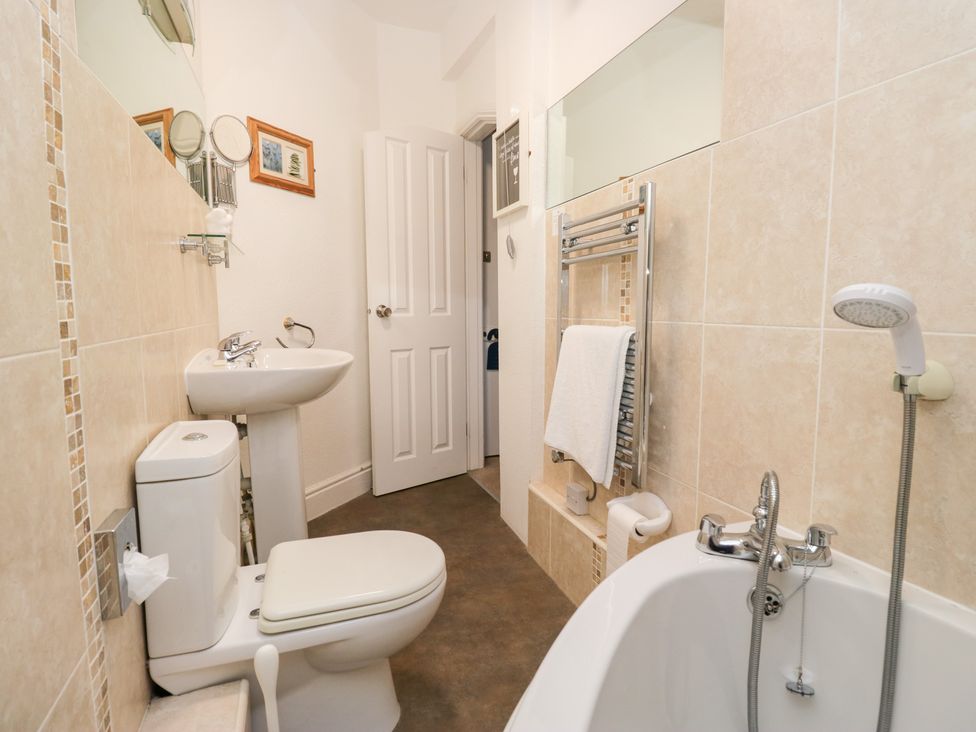 A bathroom with a toilet, sink, and bathtub at Norwood House in Ambleside