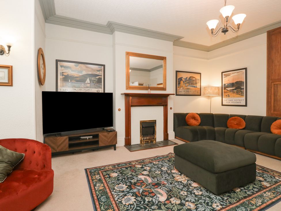 A living room with a sofa and television at Norwood House Ambleside