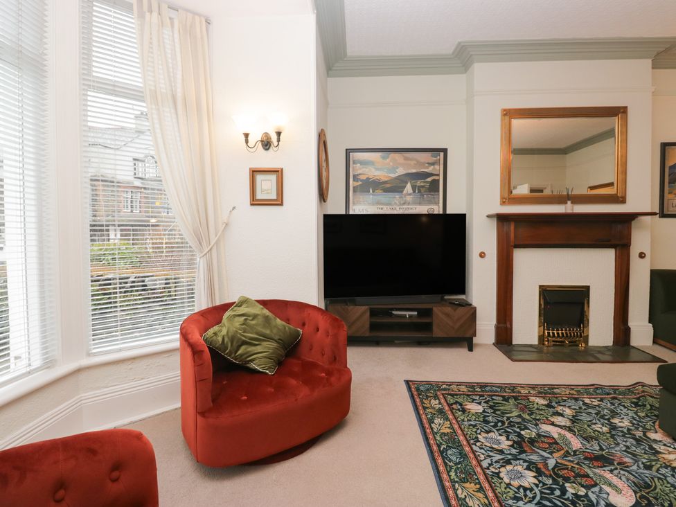 A living room with a television and fireplace at Norwood House in Ambleside