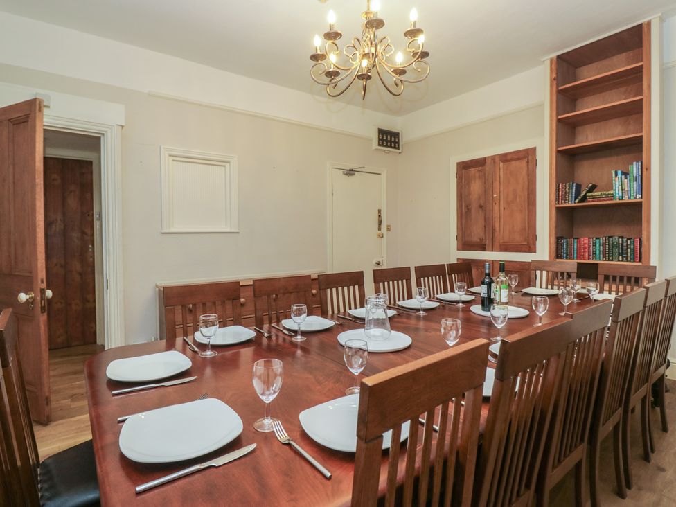 A dining room with a large table and chairs at Norwood House in Ambleside