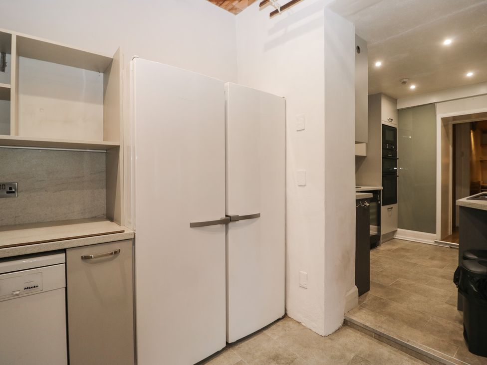 A kitchen with refrigerator and cabinets at Norwood House in Ambleside