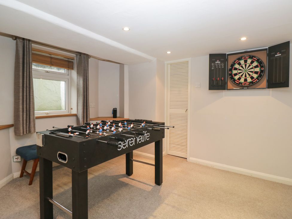 A game room with a foosball table and a dartboard at Norwood House in Ambleside