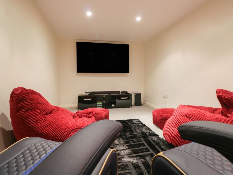 A snug with red bean bags and a TV at Norwood House in Ambleside