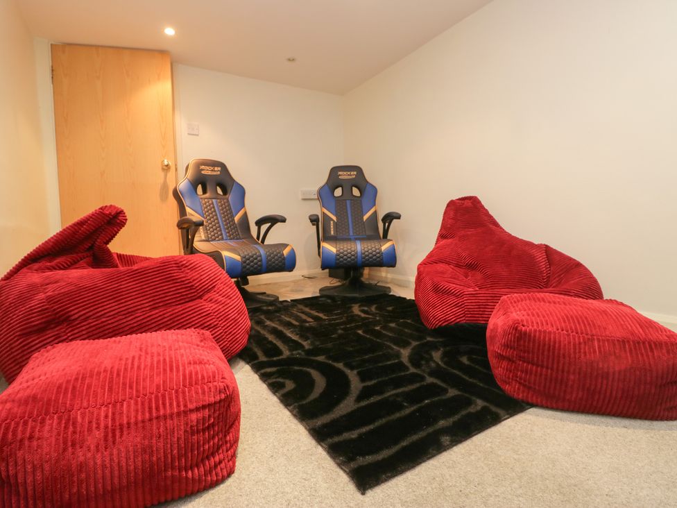 A snug room with gaming chairs and bean bags at Norwood House in Ambleside