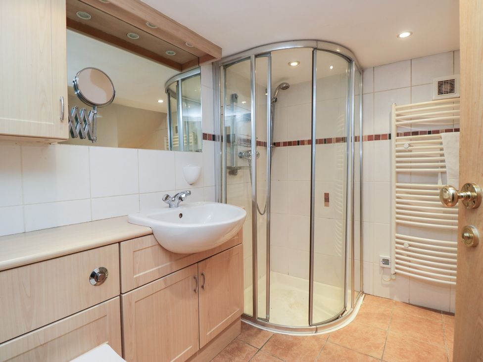 A bathroom with a shower and sink at Norwood House in Ambleside