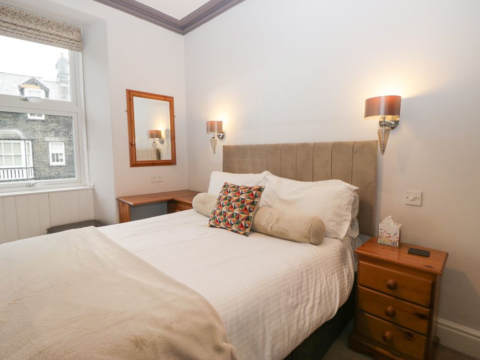 A bedroom with a bed and desk at Norwood House in Ambleside