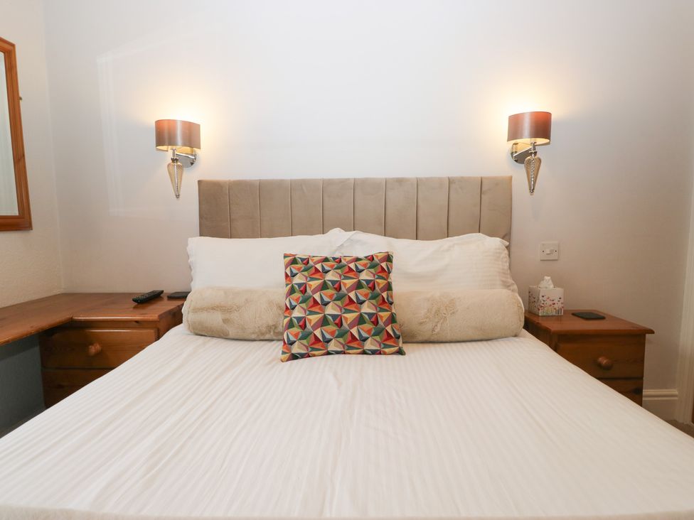 A bedroom with a bed and bedside table at Norwood House in Ambleside