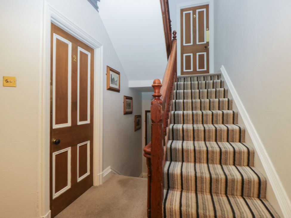 A staircase with doors on either side at Norwood House in Ambleside