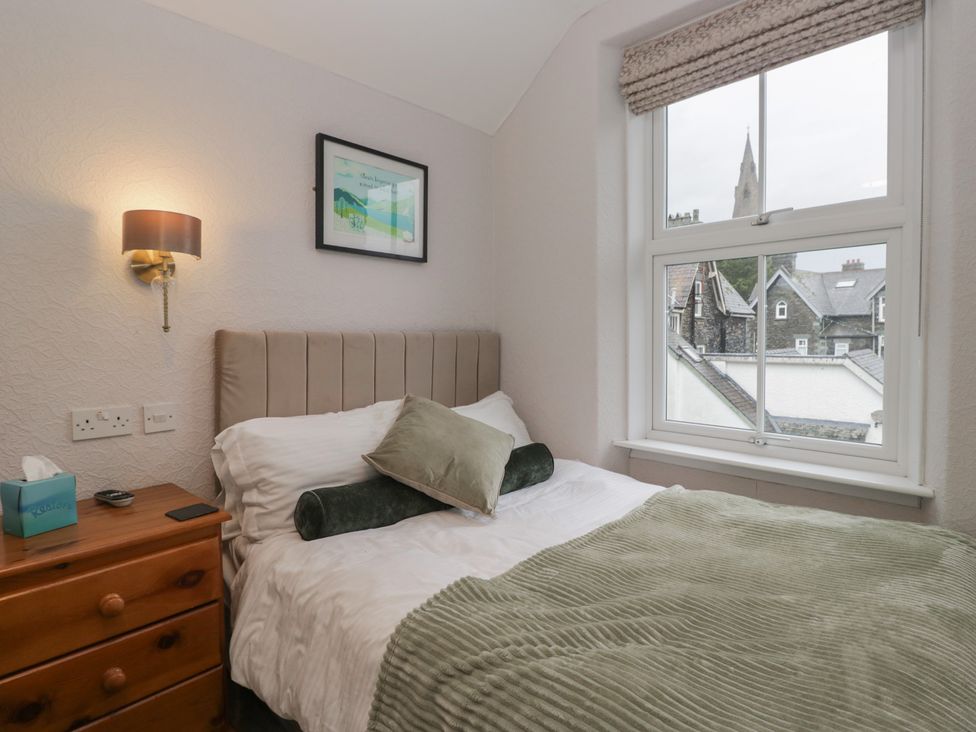 A bedroom with a bed and window at Norwood House Ambleside
