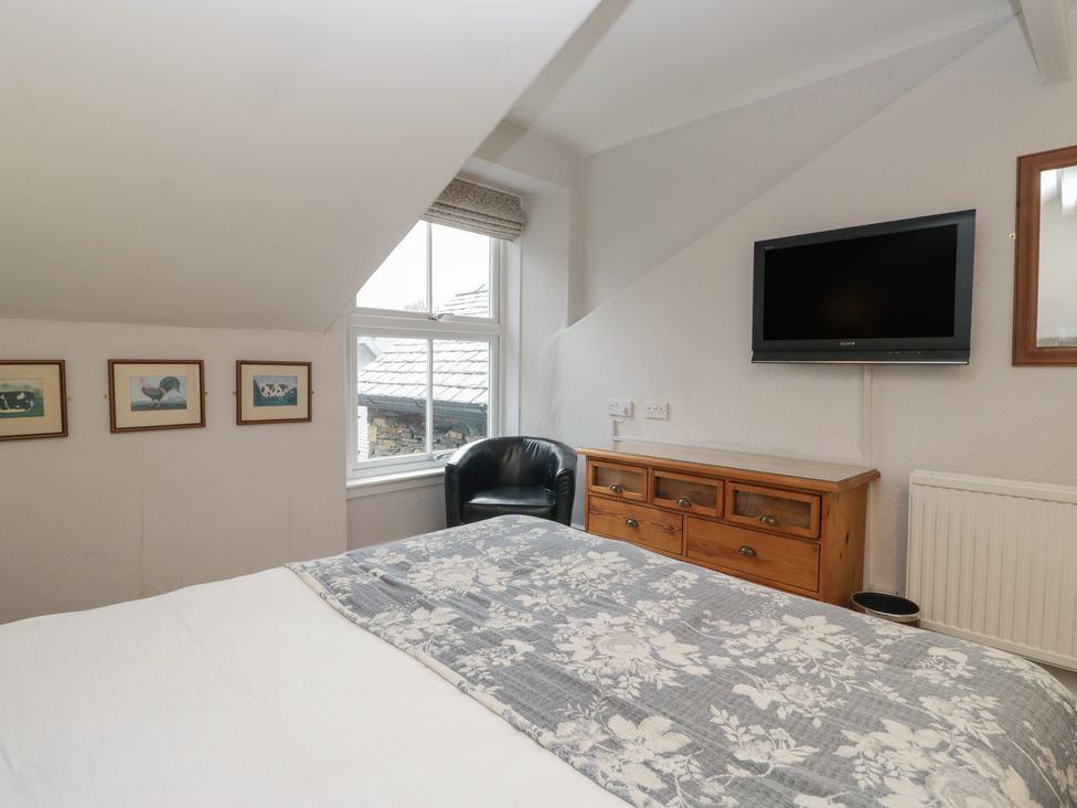 A bedroom with a bed and television at Norwood House in Ambleside