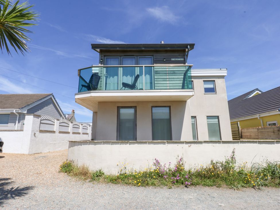 A house with a balcony and windows at Shearwater in Rhosneigr