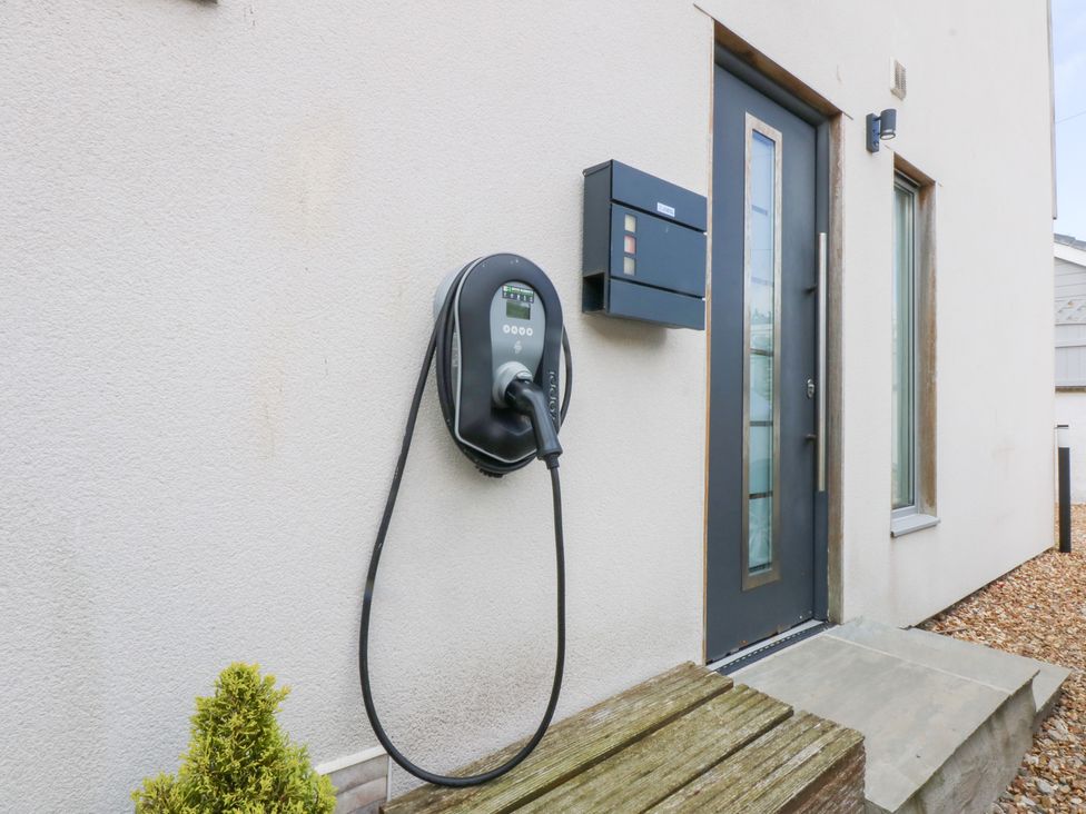 A front entrance with an electric vehicle charger and mailbox at Shearwater Rhosneigr