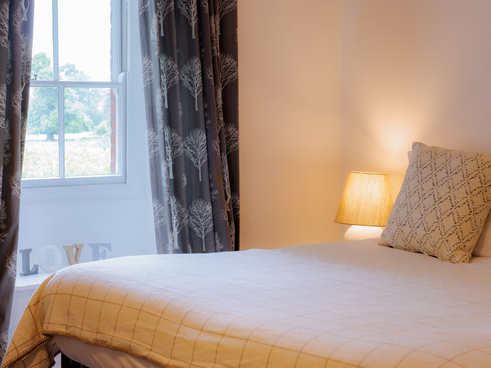 A bedroom with a bed and lamp at Stable Cottage in Bridgnorth