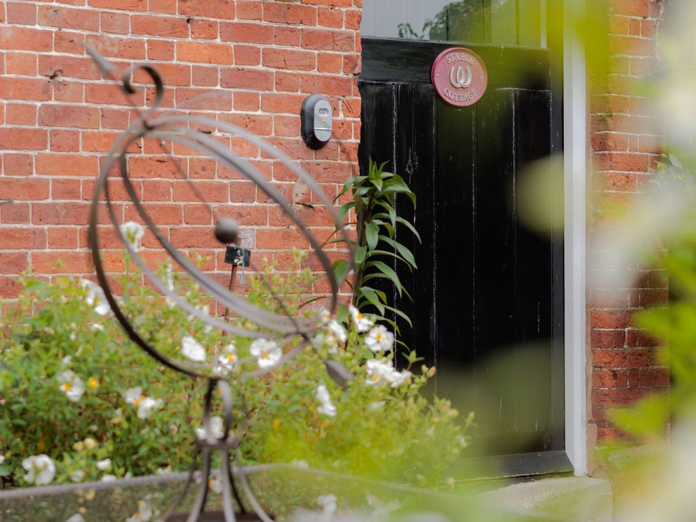 A door with a sign at Stable Cottage in Bridgnorth