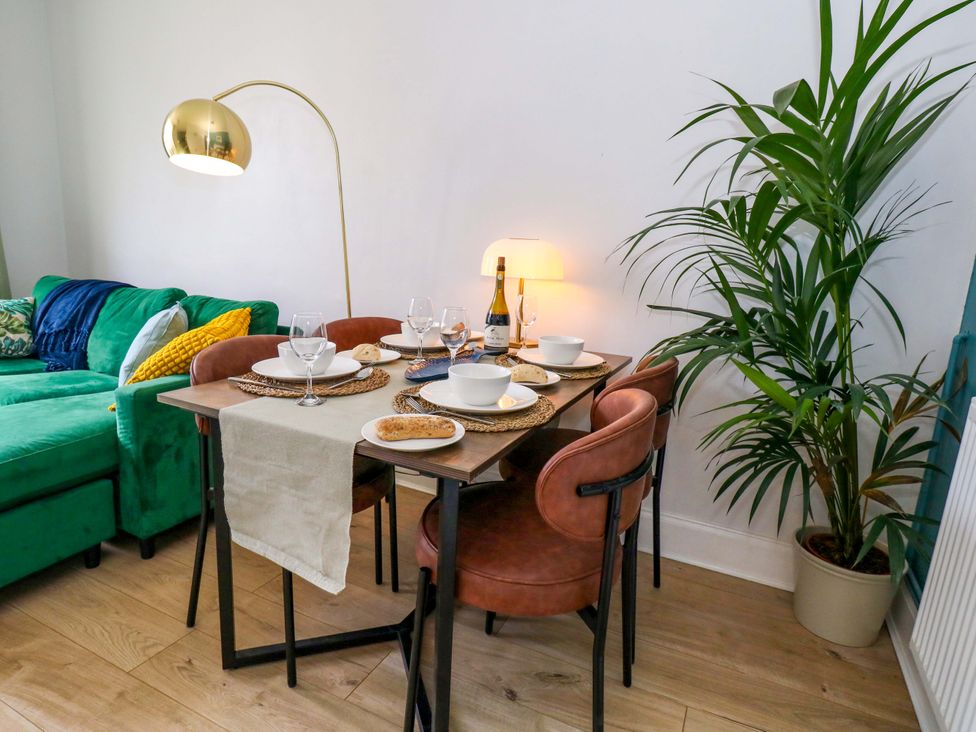 A dining area with a table set for a meal at Seagull & Chips in Weymouth