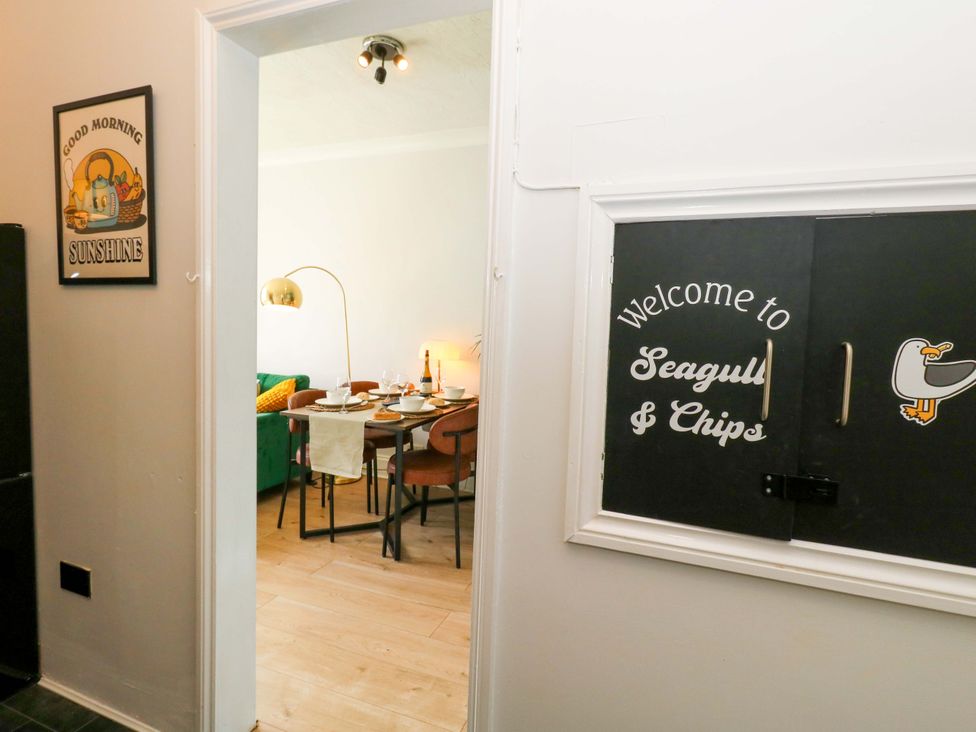 A dining room with a table and chairs at Seagull & Chips in Weymouth