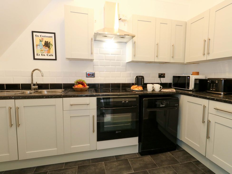 A kitchen with appliances and a fruit bowl at Seagull & Chips in Weymouth