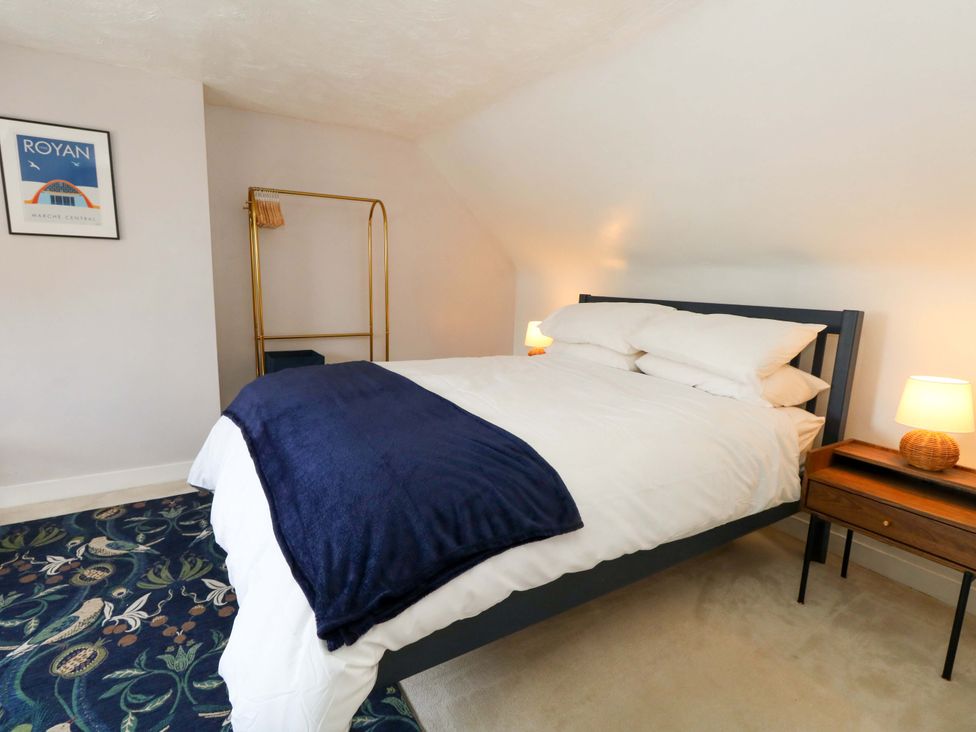 A bedroom with a bed and bedside table at Seagull & Chips in Weymouth