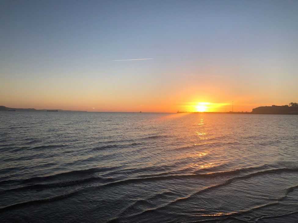 A sunset over the ocean at Seagull & Chips in Weymouth