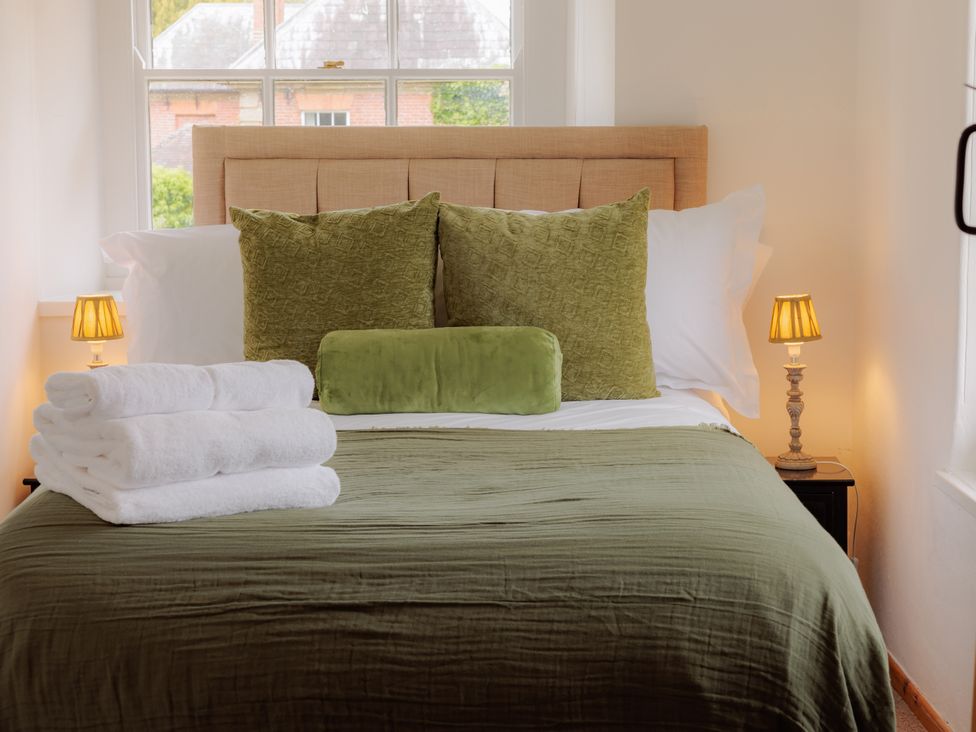 A bedroom with a bed and towels on the bed at Game Cottage in Bridgnorth