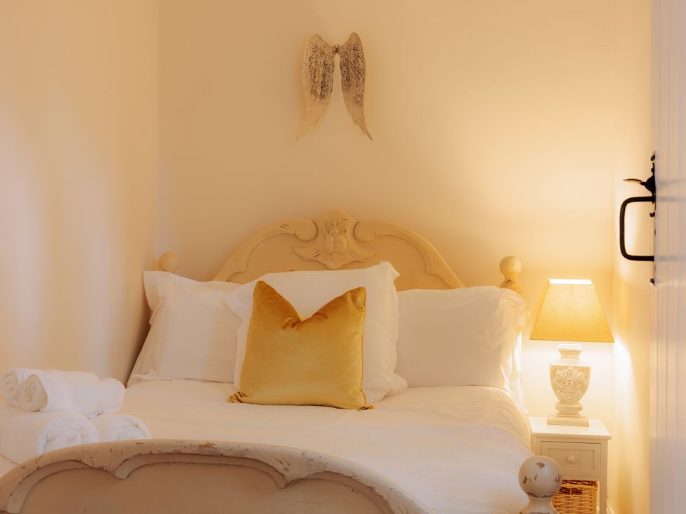 A bedroom with a bed and nightstand at The Bothy in Bridgnorth
