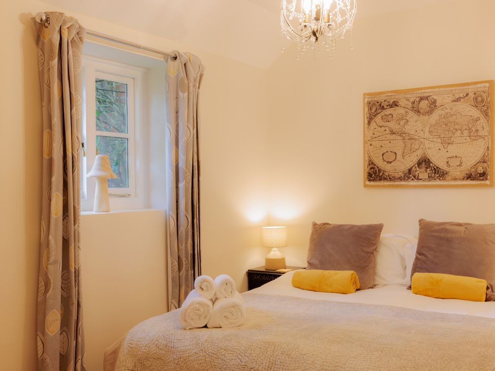 A bedroom with a bed and decorations at The Bothy in Bridgnorth