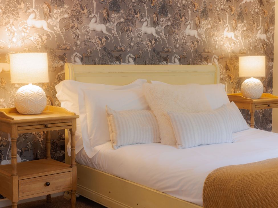 A bedroom with a bed and bedside tables at Carriage Cottage in Worfield near Bridgnorth