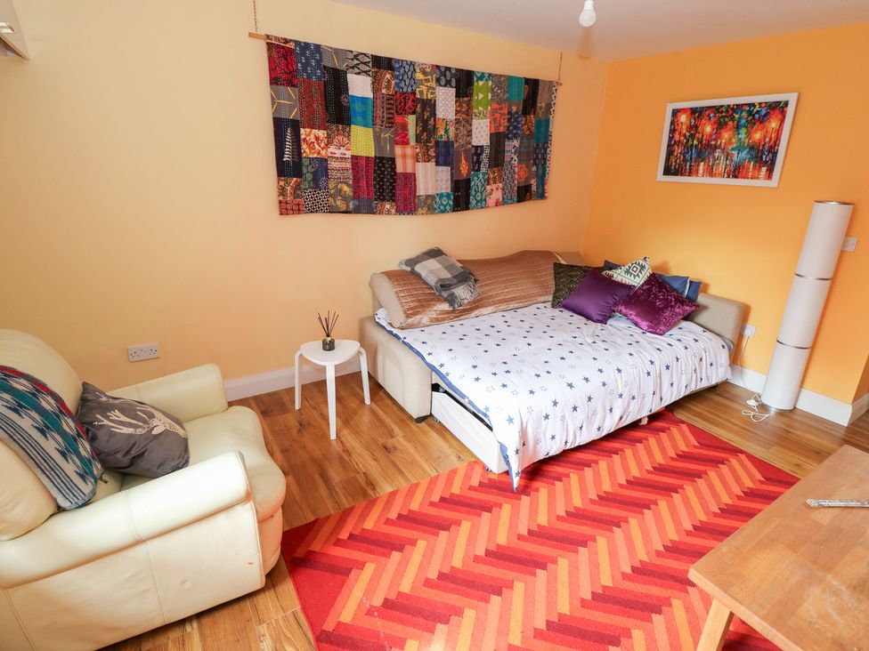 A living room with a sofa bed and coffee table at Huath in Carrick on Shannon