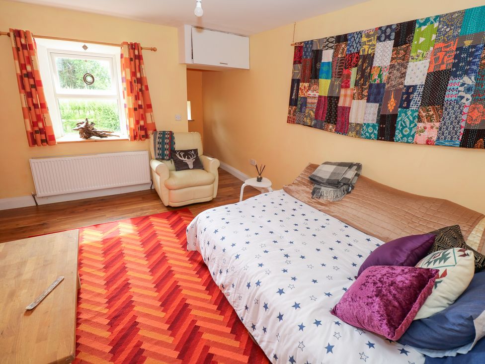 A bedroom with a bed and a chair at Huath in Carrick on Shannon