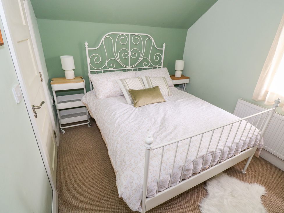 A bedroom with a bed and bedside lamp at Huath in Carrick on Shannon