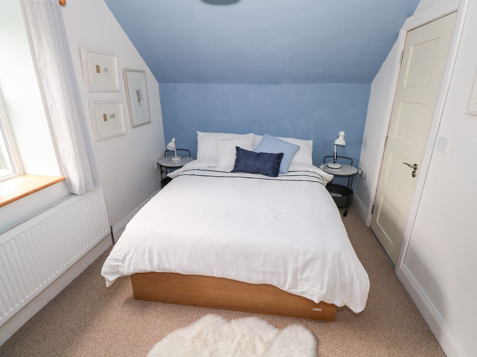 A bedroom with a bed and side tables at Huath in Carrick on Shannon