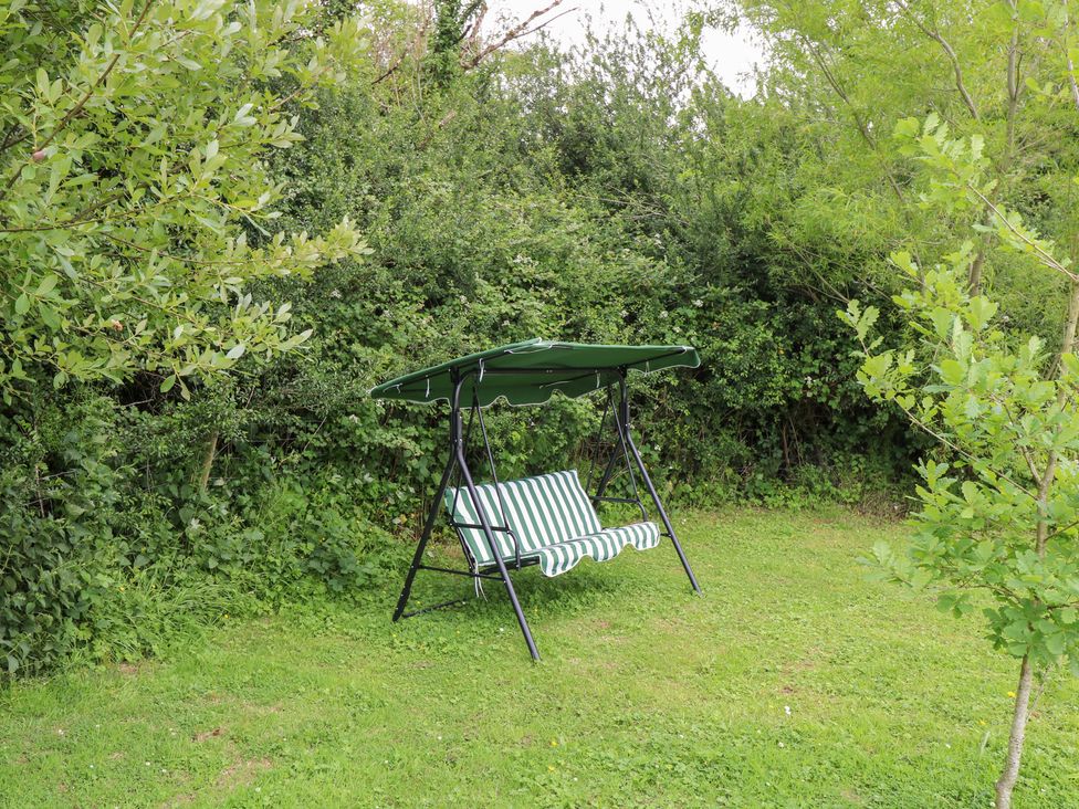 A swing chair with canopy in a garden at Huath in Carrick on Shannon