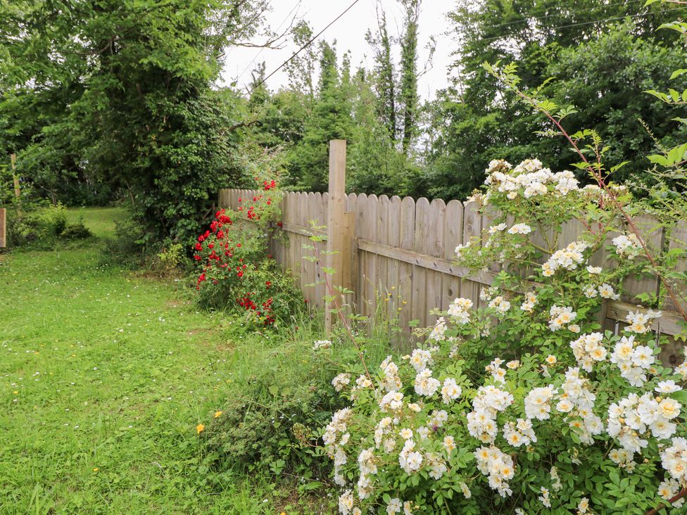 A garden with flowers and a wooden fence at Huath in Carrick on Shannon