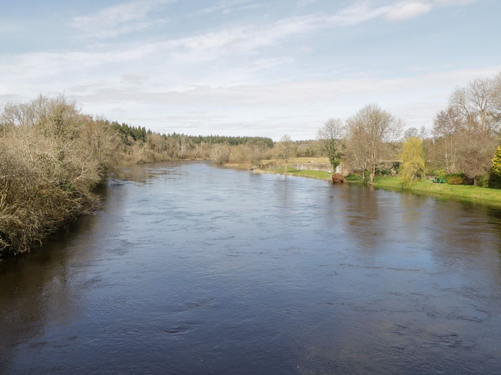 A river surrounded by trees and grass at Huath in Carrick on Shannon
