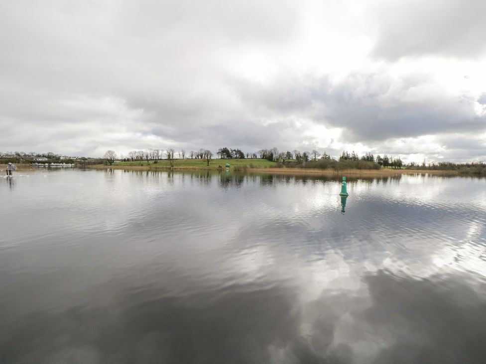 A water body with a buoy and trees at Huath in Carrick on Shannon