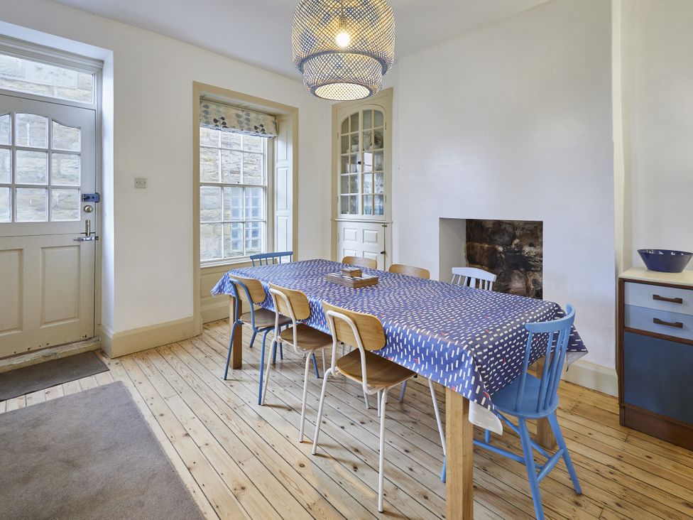 A dining room with a table and chairs at Beachside Cottage in Sandsend