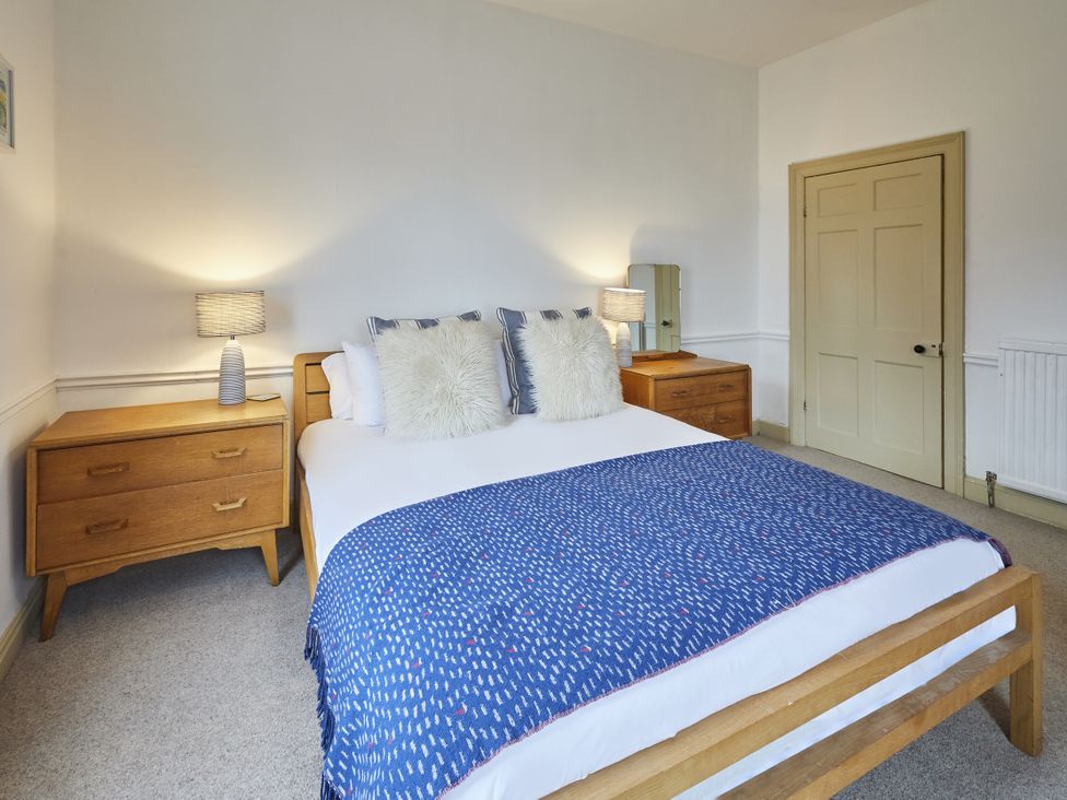 A bedroom with a bed and bedside tables at Beachside Cottage in Sandsend