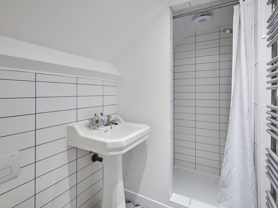 A bathroom with a sink and shower at Beachside Cottage in Sandsend