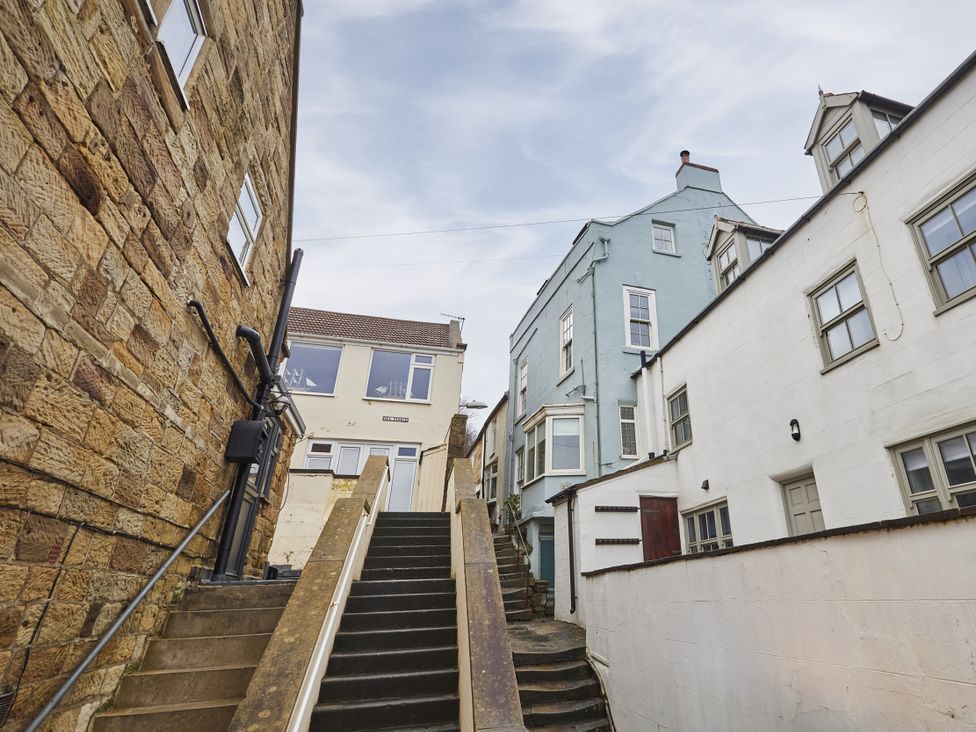 A staircase leading up between buildings at Beachside Cottage in Sandsend