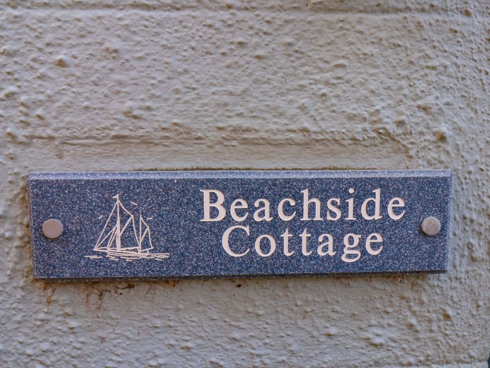 A nameplate with 'Beachside Cottage' and a boat illustration at Beachside Cottage in Sandsend