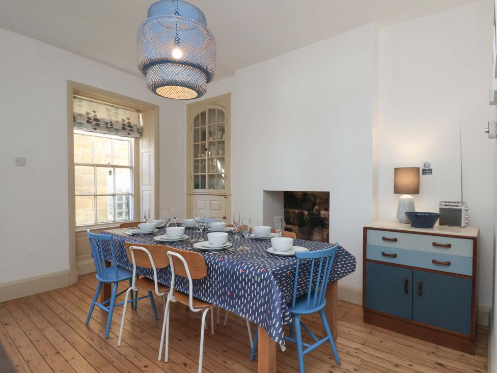 A dining room with a table and chairs at Beachside Cottage in Sandsend