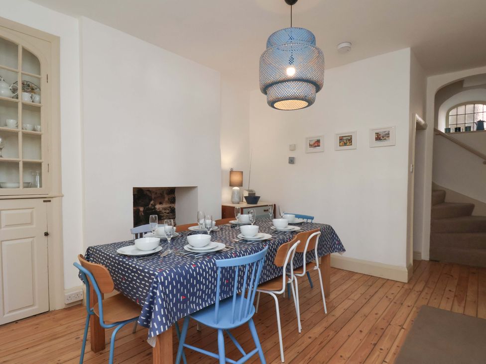 A dining room with a table set for dinner at Beachside Cottage in Sandsend
