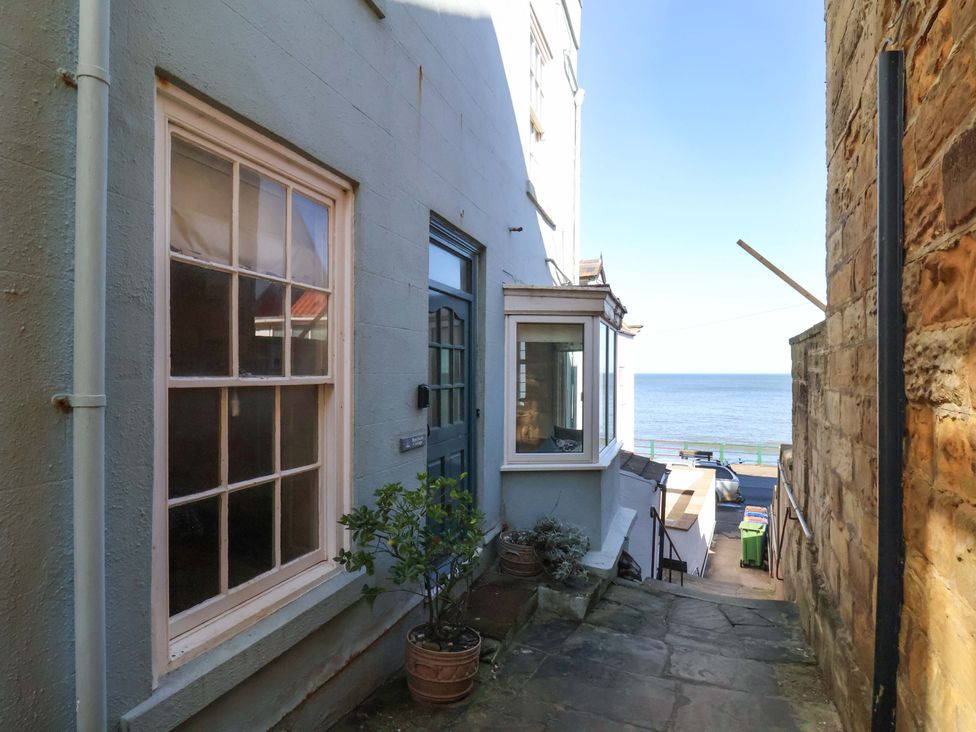 An outdoor area with a pathway and sea view at Beachside Cottage in Sandsend