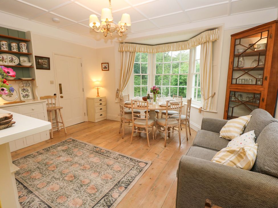 A dining room with a table and chairs at Woodlands, Freshwater